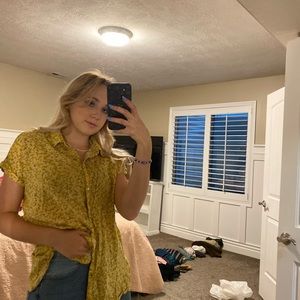Yellow flower pattern button down T-shirt with light fabric and is super flowy.
